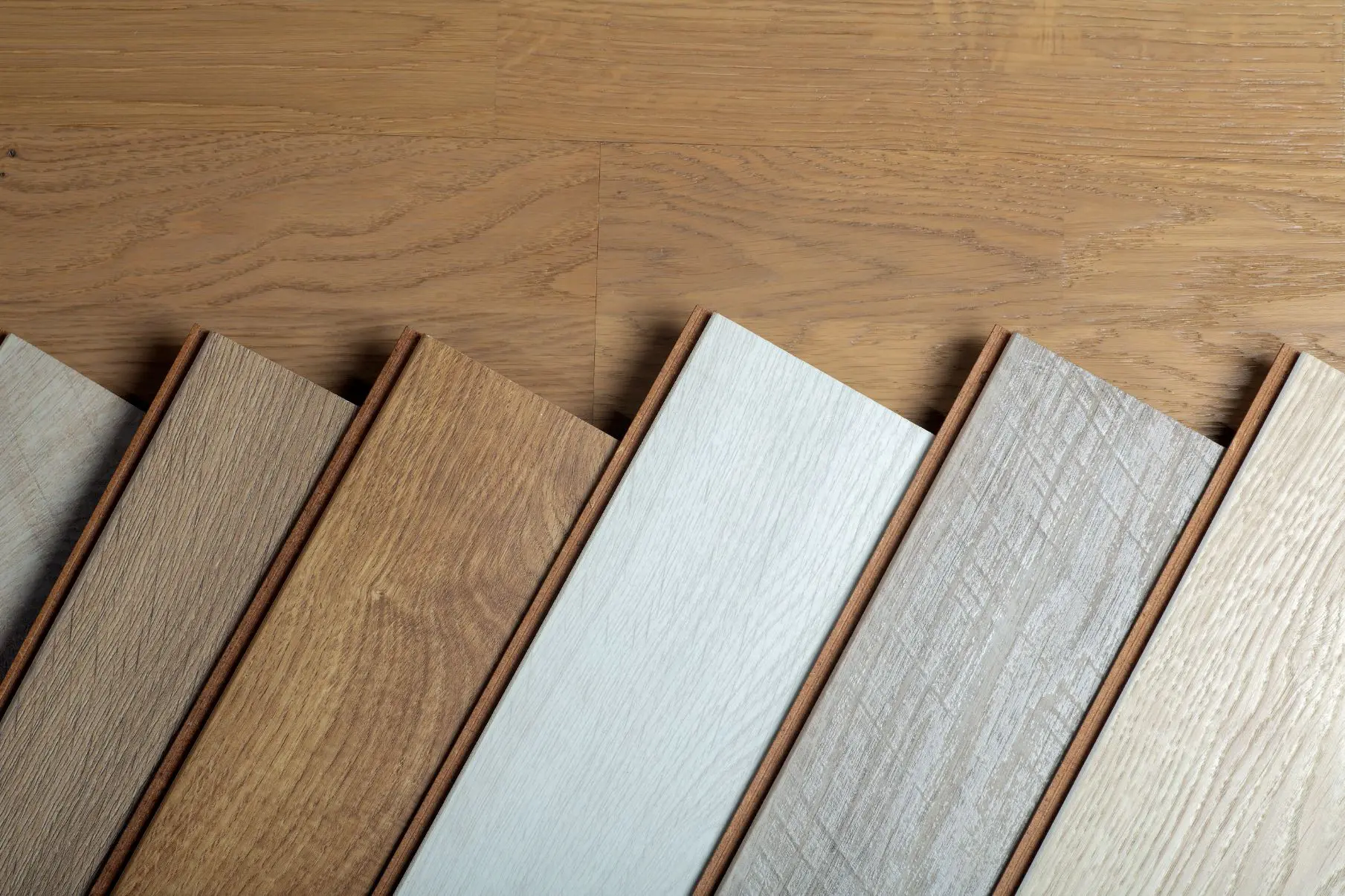 Wooden floor samples arranged in a row.