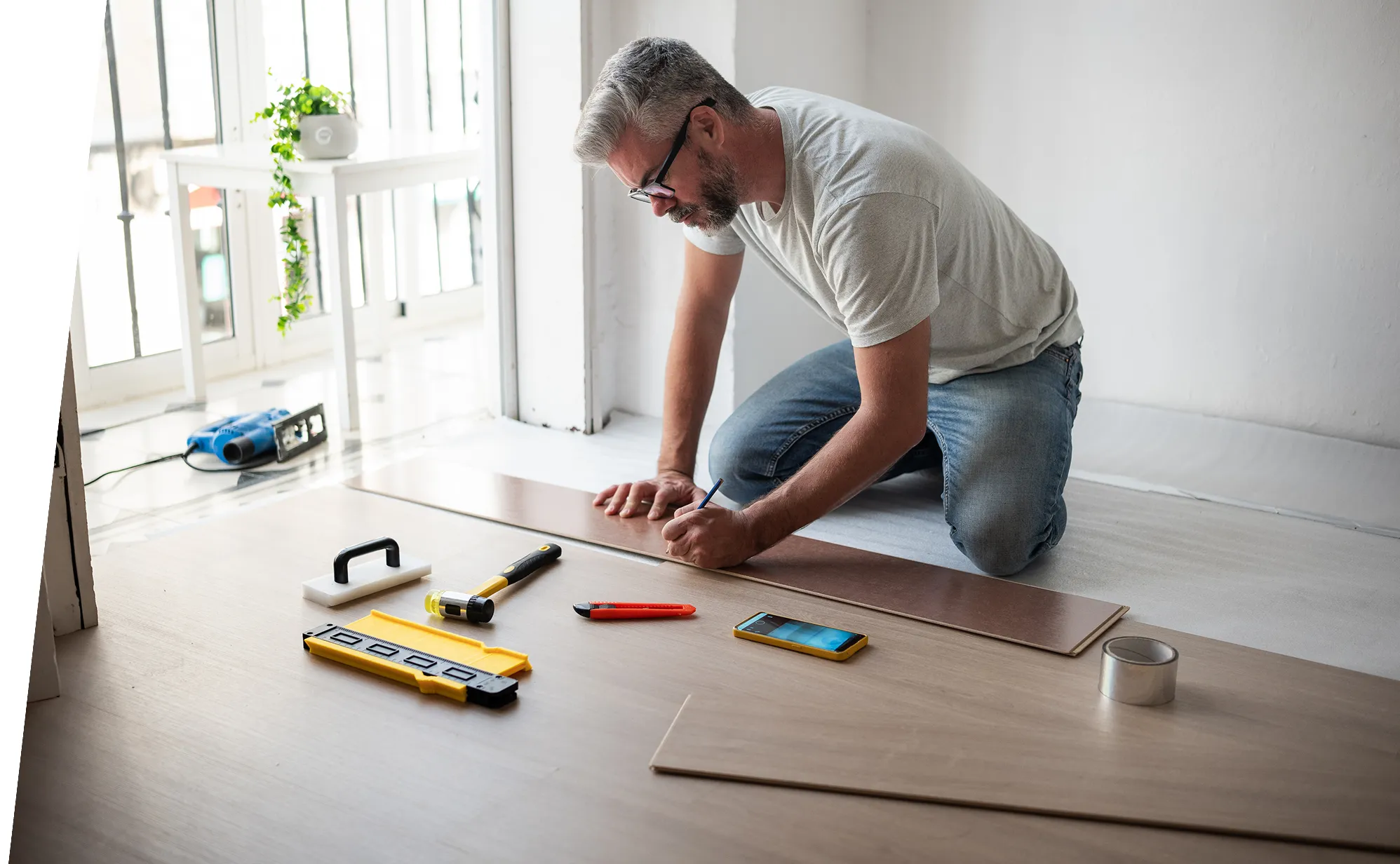 Man measuring wood for home improvement project.